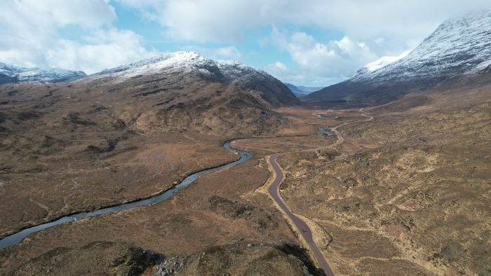Drone landscape photo of NC500 with spring snow on the hills