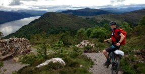 Riding a mountain bike on the Great Glen Way above Loch Ness, Scotland UK